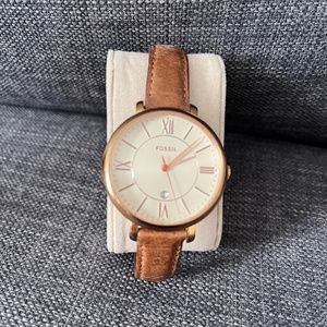 Gold Fossil watch with light brown leather band